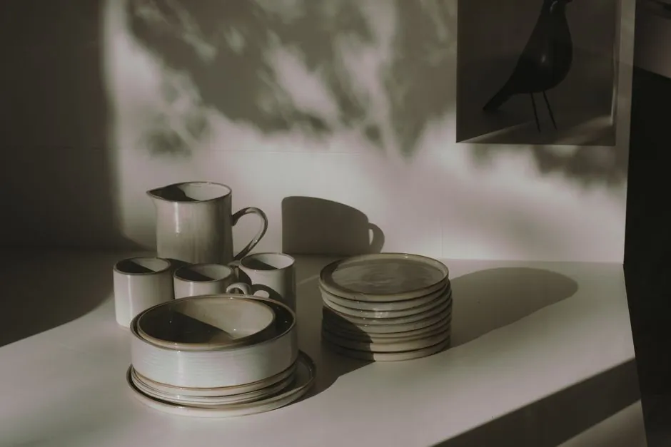 Stylish ceramic tableware set with a play of light and shadows, creating an artistic ambiance.