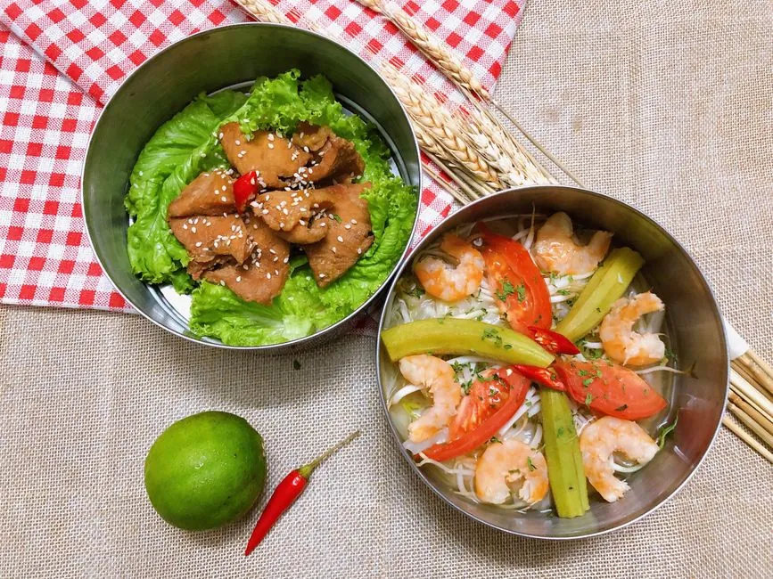 Top view of shrimp and vegetable dish with lettuce and chicken, emphasizing fresh Asian flavors.